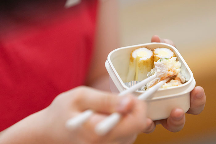 スカッシュ選手のシニア英美里(えみり)さんがお弁当を食べている写真